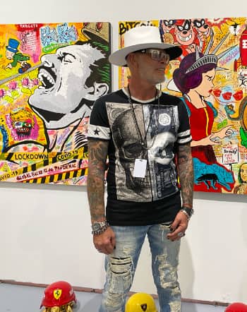 Artist Raymond Stuwe at Art Basel Miami Beach 2021, standing in front of his colorful acrylic pouring artworks.